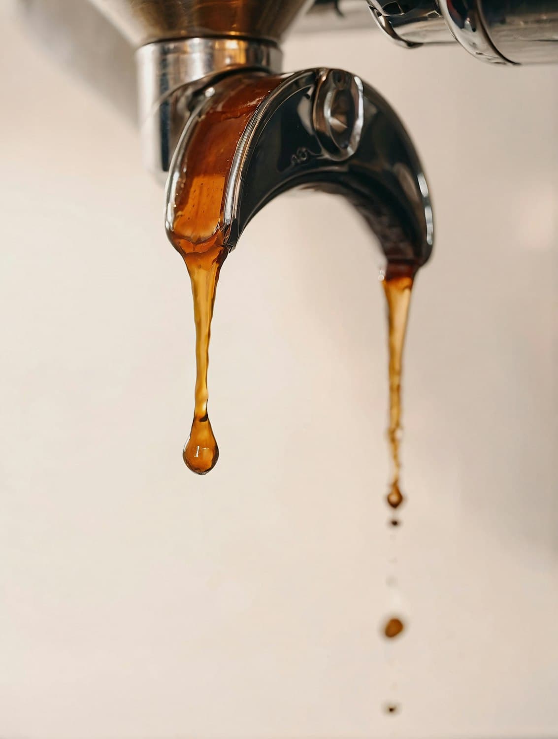 Espresso dripping from a portafilter spout